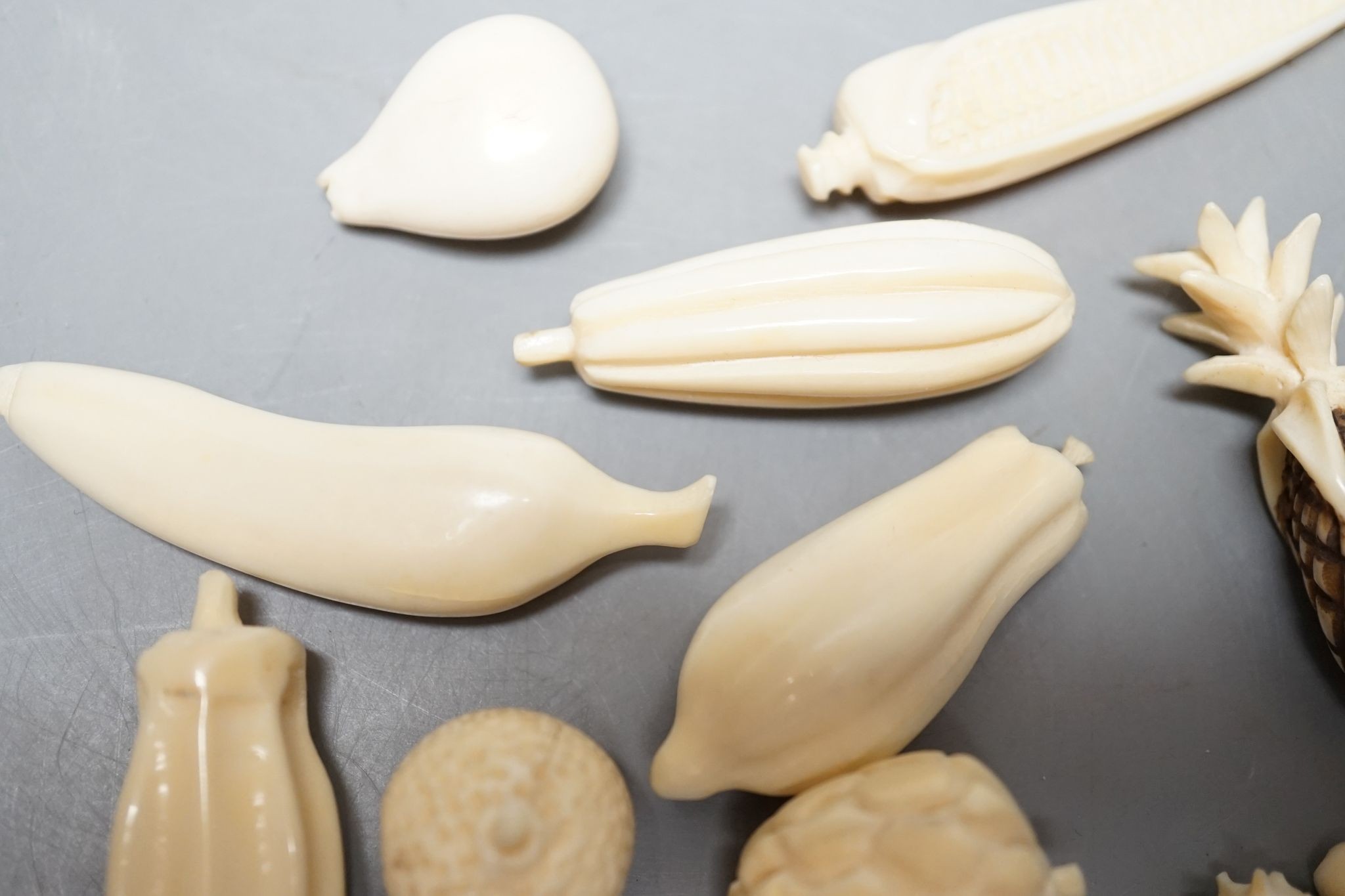 A group of Chinese carved ivory fruits, on ‘leaf’, 19cm